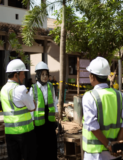 Construction crew on job site discussing project coordination