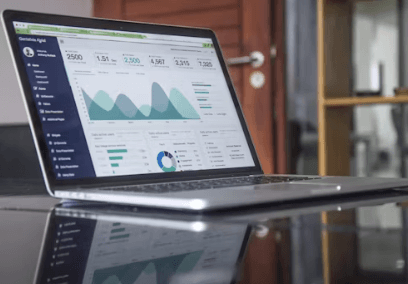 Laptop showing project documentation and reporting dashboard